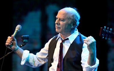 File: Grammy Award-winning American singer Art Garfunkel performs on stage at the Bloomfield Stadium in the Israeli city of Tel Aviv, on June 10, 2015. (Gil Cohen Magen/AFP)