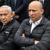 Prime Minister Benjamin Netanyahu (left) and former prime minister Naftali Bennett (right) attend the funeral of 
Rabbi Haim Drukman, at Merkaz Shapira, near Kiryat Malachi, on December 26, 2022. (Gil Cohen-Magen/ AFP)