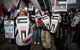 Anti-Israel activists join climate groups at a demonstration outside of the SEC Armadillo, the venue of the Annual General Meeting (AGM) of Barclays, in Glasgow on May 9, 2024. (Andy Buchanan/AFP)