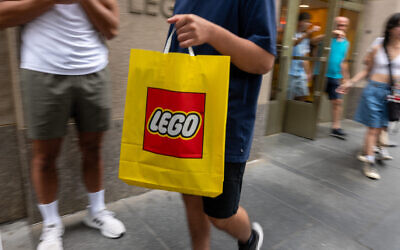People depart a Lego store in Manhattan on August 29, 2024, in New York City. (SPENCER PLATT / Getty Images via AFP)
