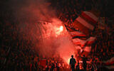 St Pauli supporters light flares during the German first division Bundesliga football match between BVB Borussia Dortmund and FC St Pauli in Dortmund, western Germany on October 18, 2024. (Ina Fassbender/AFP)