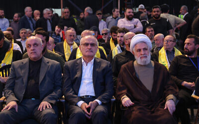 Then-deputy chief of the Lebanese Hezbollah terror group Naim Qassem (R) attends a commemoration ceremony alongside former finance minister Ali Hassan Khalil (C) and Iran's Ambassador in Lebanon Mojtaba Amani, at the memorial grave of slain Hezbollah commander Imad Mughniyeh on April 5, 2024. (Anwar Amro/AFP)