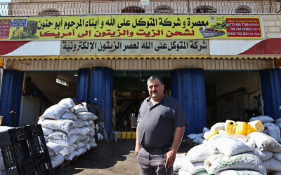 Palestinian-American entrepreneur Jamal Zaglul poses for a picture in front of his olive press in Turmus Ayya, a village in the West Bank, on October 30, 2024. (Zain Jaafar/AFP)
