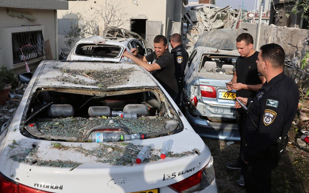 Police officers and residents check the damage following a Hezbollah rocket attack from southern Lebanon that targeted the central Arab town of Tira, on November 2, 2024. (Jack Guez/AFP)