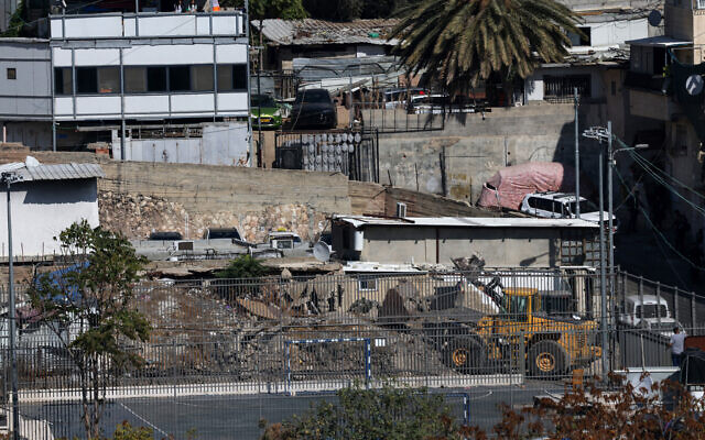 An Israeli excavator demolishes an illegaly built house belonging to the Palestinian Ruwaidi family in Silwan in East Jerusalem on November 5, 2024. (Photo by AHMAD GHARABLI / AFP)