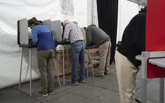 People vote in a voting tent on the day of the US presidential election, in Burnsville, North Carolina, on November 5, 2024. (Allison Joyce / AFP)
