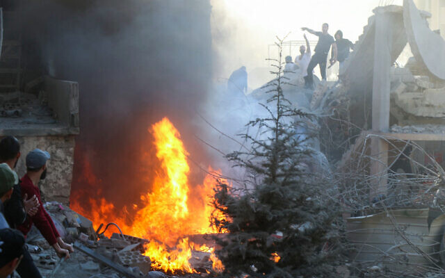 People and rescuers try to put out a fire at the site of an Israeli airstrike in Lebanon's eastern city of Baalbek, November 6, 2024. (Nidal Solh/AFP) People and rescuers try to put out a fire at the site of an Israeli airstrike in Lebanon's eastern city of Baalbek, November 6, 2024. (Nidal Solh/AFP)