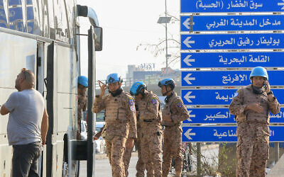 Members of the UNIFIL peacekeeping force stand at the site of an Israeli strike at the northern entrance of the southern city of Sidon, on November 7, 2024. (Mahmoud Zayyat/AFP)