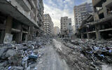 People inspect the damage at the site of overnight Israeli airstrikes that targeted the Rweiss neighborhood in Beirut's southern suburbs on November 9, 2024. (Ibrahim Amro/AFP)