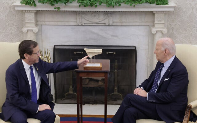 President Isaac Herzog (L) of Israel presents US President Joe Biden (R) with an artifact from the foot of Temple Mount in Jerusalem that has the word "Joseph" on it during a meeting in the Oval Office of the White House on November 12, 2024 in Washington, DC. (Alex Wong / Getty Images via AFP)