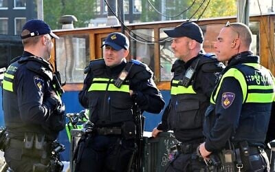ILLUSTRATIVE: Police officers stand outside Amsterdam City Council on November 12, 2024, days after the Dutch capital was rocked by attacks on Israeli soccer fans in several locations across the city. (Photo by Nick Gammon/AFP) ILLUSTRATIVE: Police officers stand outside Amsterdam City Council on November 12, 2024, days after the Dutch capital was rocked by attacks on Israeli soccer fans in several locations across the city. (Photo by Nick Gammon/AFP)