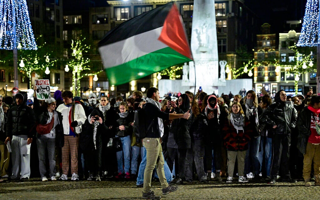 A protestor waves a Palestinian flag during an unauthorized pro-Palestinian, anti-Israel demonstration on Dam Square in Amsterdam on November 13, 2024. (Nick Gammon / AFP)