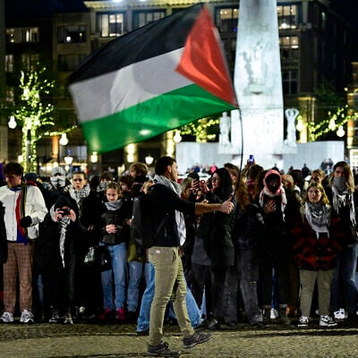 A protestor waves a Palestinian flag during an unauthorized pro-Palestinian, anti-Israel demonstration on Dam Square in Amsterdam on November 13, 2024. (Nick Gammon / AFP)