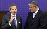 Iran's Atomic Energy Organization head Mohammad Eslami (R), listens to International Atomic Energy Agency chief Rafael Grossi, following a joint press conference in Tehran on November 14, 2024. (ATTA KENARE / AFP)