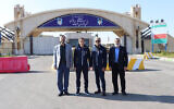 Atomic Energy Organization of Iran spokesman Behrouz Kamalvandi (R) and Iran's Deputy Foreign Minister Kazem Gharib Abadi (L), posing for a picture with the International Atomic Energy Agency (IAEA) chief Rafael Grossi (2nd L), in front of the gate of the Natanz nuclear enrichment plant in Iran's Isfahan province, November 15, 2024. (Atomic Energy Organization of Iran / AFP)