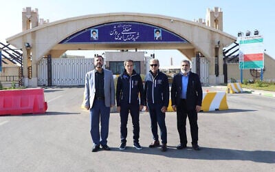 Atomic Energy Organization of Iran spokesman Behrouz Kamalvandi (R) and Iran's Deputy Foreign Minister Kazem Gharib Abadi (L), posing for a picture with the International Atomic Energy Agency (IAEA) chief Rafael Grossi (2nd L), in front of the gate of the Natanz nuclear enrichment plant in Iran's Isfahan province, November 15, 2024. (Atomic Energy Organization of Iran / AFP)