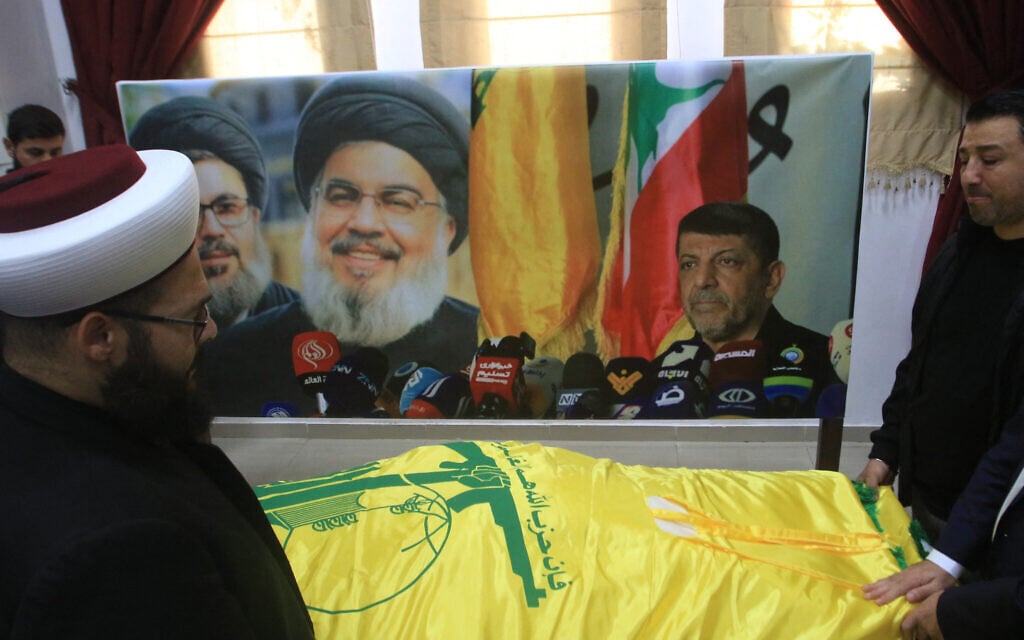 Mourners gather around the coffin of Hezbollah's media relations chief Mohammed Afif during his funeral in the southern Lebanese city of Sidon on November 18, 2024, a day after he was killed in an Israeli strike (Photo by Mahmoud ZAYYAT / AFP)