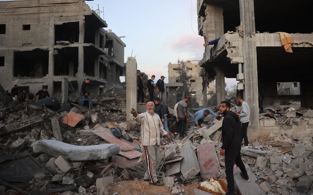 Palestinians inspect the damage at the site of an Israeli airstrike on the Bureij refugee camp in the central Gaza Strip on November 19, 2024. (Eyad BABA / AFP)