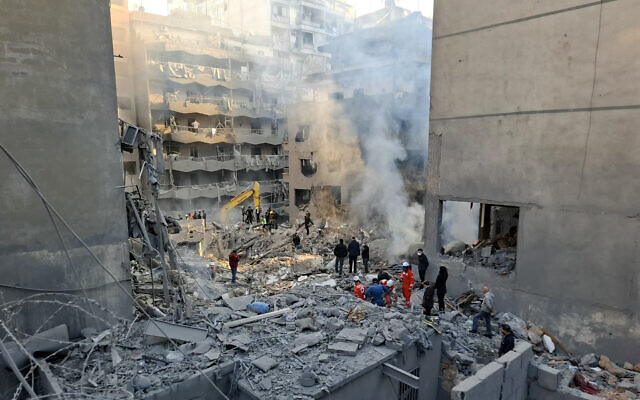 FILE: People gather as rescuers sift through the rubble of a leveled building, following an overnight Israeli airstrike that targeted Beirut's Basta neighborhood on November 23, 2024.(Fadel Itani/AFP) FILE: People gather as rescuers sift through the rubble of a leveled building, following an overnight Israeli airstrike that targeted Beirut's Basta neighborhood on November 23, 2024.(Fadel Itani/AFP)