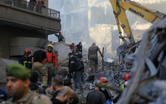 Rescuers sift through the rubble of a leveled building in search of victims or survivors, following an overnight Israeli airstrike that targeted Beirut's Basta neighborhood on November 23, 2024.(AFP) Rescuers sift through the rubble of a leveled building in search of victims or survivors, following an overnight Israeli airstrike that targeted Beirut's Basta neighborhood on November 23, 2024.(AFP)