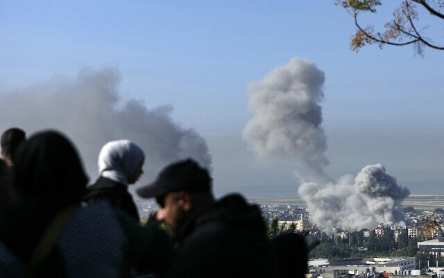 People watch as smoke rises following an Israeli airstrike in southern Beirut, adjacent to the runway of the international airport, on November 23, 2024, amid the ongoing war between Israel and Hezbollah. - (Photo by IBRAHIM AMRO / AFP) People watch as smoke rises following an Israeli airstrike in southern Beirut, adjacent to the runway of the international airport, on November 23, 2024, amid the ongoing war between Israel and Hezbollah. - (Photo by IBRAHIM AMRO / AFP)