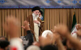 A handout picture provided by the office of Iran's Supreme Leader Ayatollah Ali Khamenei shows him greeting the crowd during a meeting with members of the Basij volunteer Islamic militia in Tehran on November 25, 2024. (KHAMENEI.IR / AFP)