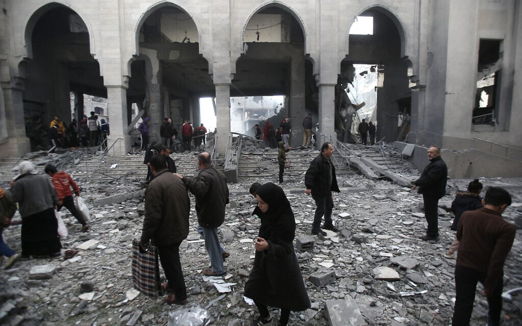 Palestinians inspect the damage at the site of an Israeli airstrike in the Nuseirat camp in central Gaza on November 27, 2024. (Eyad BABA / AFP)