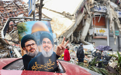 A driver holds up portraits of Hezbollah's slain leaders Hassan Nasrallah and Hashem Safieddine as people return to Beirut’s southern suburbs on November 27, 2024, after a ceasefire between Israel and Hezbollah took effect. (Ibrahim Amro/ AFP) A driver holds up portraits of Hezbollah's slain leaders Hassan Nasrallah and Hashem Safieddine as people return to Beirut’s southern suburbs on November 27, 2024, after a ceasefire between Israel and Hezbollah took effect. (Ibrahim Amro/ AFP)