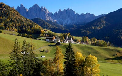 Illustrative: Colorful trees stand around a church at the Dolomites mountains in St. Maddalena, St. Magdalena, in Val di Funes (Villnoess) as the sun sets, in northern Italian province of South Tyrol, Italy, Thursday, Oct. 28, 2021. (AP Photo/Matthias Schrader)