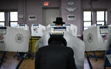 Members of the Orthodox jewish community fill out ballot papers at a polling center on November 8, 2022, in the Brooklyn borough of New York. (AP Photo/Wong Maye-E)