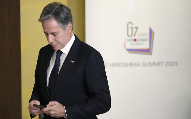 Illustrative: US Secretary of State Antony Blinken looks at his cellphone as he walks for a group photo session during the G7 foreign ministers meetings at the Iikura Guest House, November 8, 2023, in Tokyo. (AP Photo/Eugene Hoshiko, Pool) Illustrative: US Secretary of State Antony Blinken looks at his cellphone as he walks for a group photo session during the G7 foreign ministers meetings at the Iikura Guest House, November 8, 2023, in Tokyo. (AP Photo/Eugene Hoshiko, Pool)