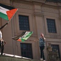 Pro-Palestinian, anti-Israel demonstrators wave flags over the Brooklyn Museum during a protest demanding a permanent ceasefire in Gaza, in the Brooklyn borough of New York, May 31, 2024. (AP Photo/Andres Kudacki)