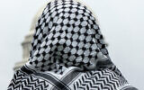 FILE - A man wearing a keffiyeh looks at the US Capitol during a pro-Palestinian, anti-Israel rally, on May 18, 2024, on the National Mall in Washington. (AP Photo/Jacquelyn Martin, File)
