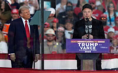 Republican presidential nominee former President Donald Trump listens as Elon Musk speaks during a campaign rally at the Butler Farm Show, October 5, 2024, in Butler, Pennsylvania. (AP/Julia Demaree Nikhinson)