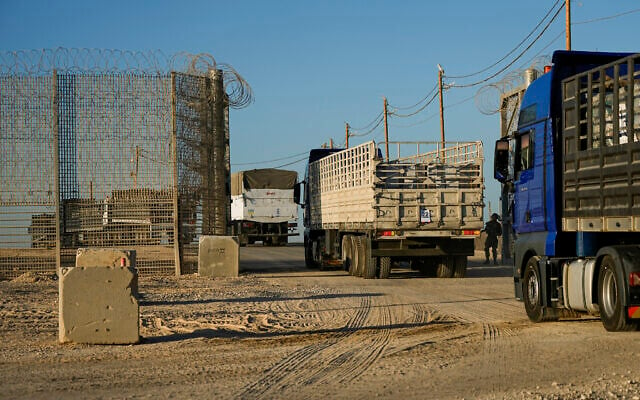 Trucks carrying humanitarian aid cross into the Gaza Strip from Erez crossing in southern Israel, Monday, October 21, 2024. (AP Photo/Tsafrir Abayov)