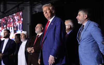 Republican US presidential nominee former president Donald Trump, center, stands alongside local Muslim leaders during a campaign rally at the Suburban Collection Showplace, October 26, 2024, in Novi, Michigan. (AP Photo/Alex Brandon)