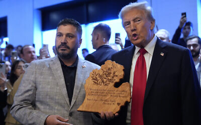 Republican presidential nominee and former US president Donald Trump talks with owner Albert Abbas as he visits The Great Commoner restaurant, November 1, 2024, in Dearborn, Michigan. (AP Photo/Julia Demaree Nikhinson)