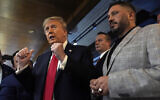 Republican presidential nominee former president Donald Trump talks during a visit to The Great Commoner, as owner Albert Abbas, right, listens, in Dearborn, Michigan November 1, 2024,. (Julia Demaree Nikhinson/AP)