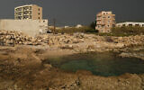 A building, left, in Batroun, northern Lebanon, November 2, 2024, where a Hezbollah ship captain was taken away by IDF commandos who landed on a coast north of Beirut. (AP Photo/Hussein Malla)