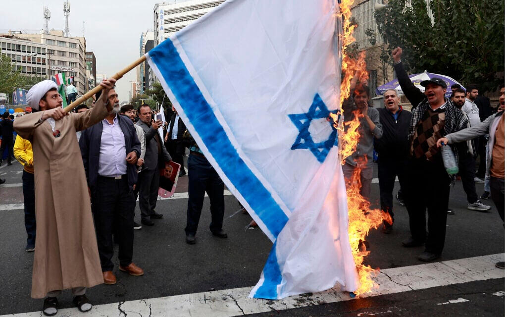 Iranian demonstrators burn a representation of the Israeli flag in an annual rally in front of the former US Embassy in Tehran, Iran, Nov. 3, 2024, marking the 45th anniversary of Iranian students' takeover of the embassy, starting a hostage crisis. (AP Photo/Vahid Salemi)