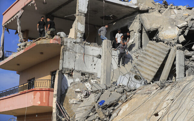 People search for victims at a destroyed building hit in an Israeli airstrike, in Ghaziyeh, southern Lebanon, Sunday, Nov. 3, 2024. (AP/Mohammed Zaatari)