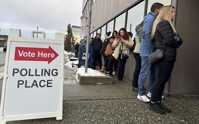 People waiting to vote November 4, 2024, stand in a long line that wrapped around the Alaska Division of Elections regional office in Anchorage, Alaska. (AP Photo/Mark Thiessen)