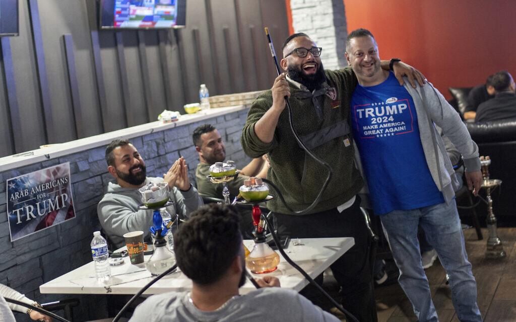Abrahim Tamimi, left, and Nabeel Hamameh celebrate while watching results come in during an Arab Americans for Trump watch party at the Lava Java Cafe, a hookah lounge, in the early hours of Wednesday, Nov. 6, 2024, in Dearborn, Mich. (AP Photo/David Goldman) Abrahim Tamimi, left, and Nabeel Hamameh celebrate while watching results come in during an Arab Americans for Trump watch party at the Lava Java Cafe, a hookah lounge, in the early hours of Wednesday, Nov. 6, 2024, in Dearborn, Mich. (AP Photo/David Goldman)