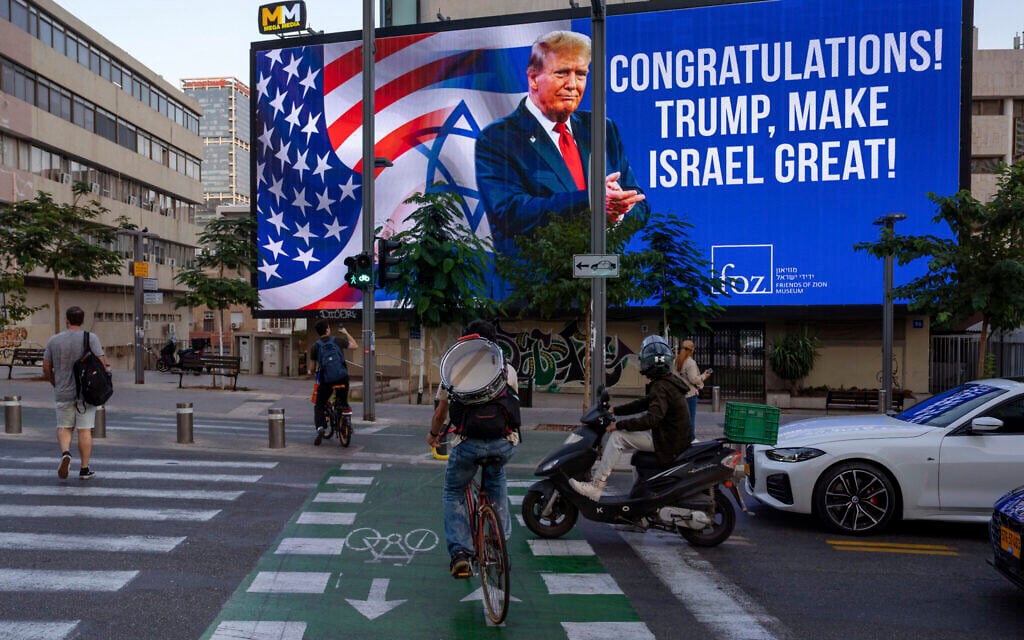 A billboard that displays a photo of US President-elect Donald Trump and reads 'Congratulations! Trump, make Israel great' is projected a day after the US election, in Tel Aviv, Israel, November 6, 2024. (AP Photo/Oded Balilty)