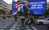 A billboard that displays a photo of US President-elect Donald Trump and reads 'Congratulations! Trump, make Israel great' is projected a day after the US election, in Tel Aviv, Israel, November 6, 2024. (AP Photo/Oded Balilty)