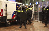 In this image taken from video, police detain a man near the Ajax stadium, after anti-Israel protesters marched despite a ban on demonstrations near the soccer stadium, in Amsterdam, November 7, 2024. (AP Photo InterVision)