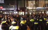 In this image taken from video, police stand guard forming a line near the Ajax stadium, in Amsterdam, the Netherlands, November 7, 2024. Maccabi Tel Aviv fans were targeted by anti-Israel rioters in an apparently pre-planned attack following a soccer match in the Ajax stadium. (AP Photo InterVision)