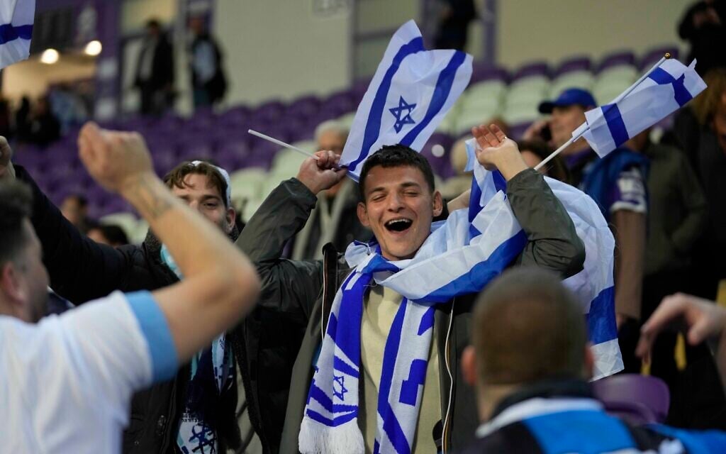 Israel supporters wave flags during the Euro 2024 qualifying play-off soccer match between Israel and Iceland, at Szusza Ferenc Stadium in Budapest, Hungary, Thursday, March 21, 2024. (AP Photo/Darko Vojinovic, File) Israel supporters wave flags during the Euro 2024 qualifying play-off soccer match between Israel and Iceland, at Szusza Ferenc Stadium in Budapest, Hungary, Thursday, March 21, 2024. (AP Photo/Darko Vojinovic, File)