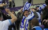 Israel supporters wave flags during the Euro 2024 qualifying play-off soccer match between Israel and Iceland, at Szusza Ferenc Stadium in Budapest, Hungary, Thursday, March 21, 2024. (AP Photo/Darko Vojinovic, File)