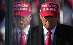 Republican presidential nominee Donald Trump is reflected in the bullet proof glass as he finishes speaking at a campaign rally in Lititz, Pennsylvania, November 3, 2024. (AP Photo/Matt Rourke, File)